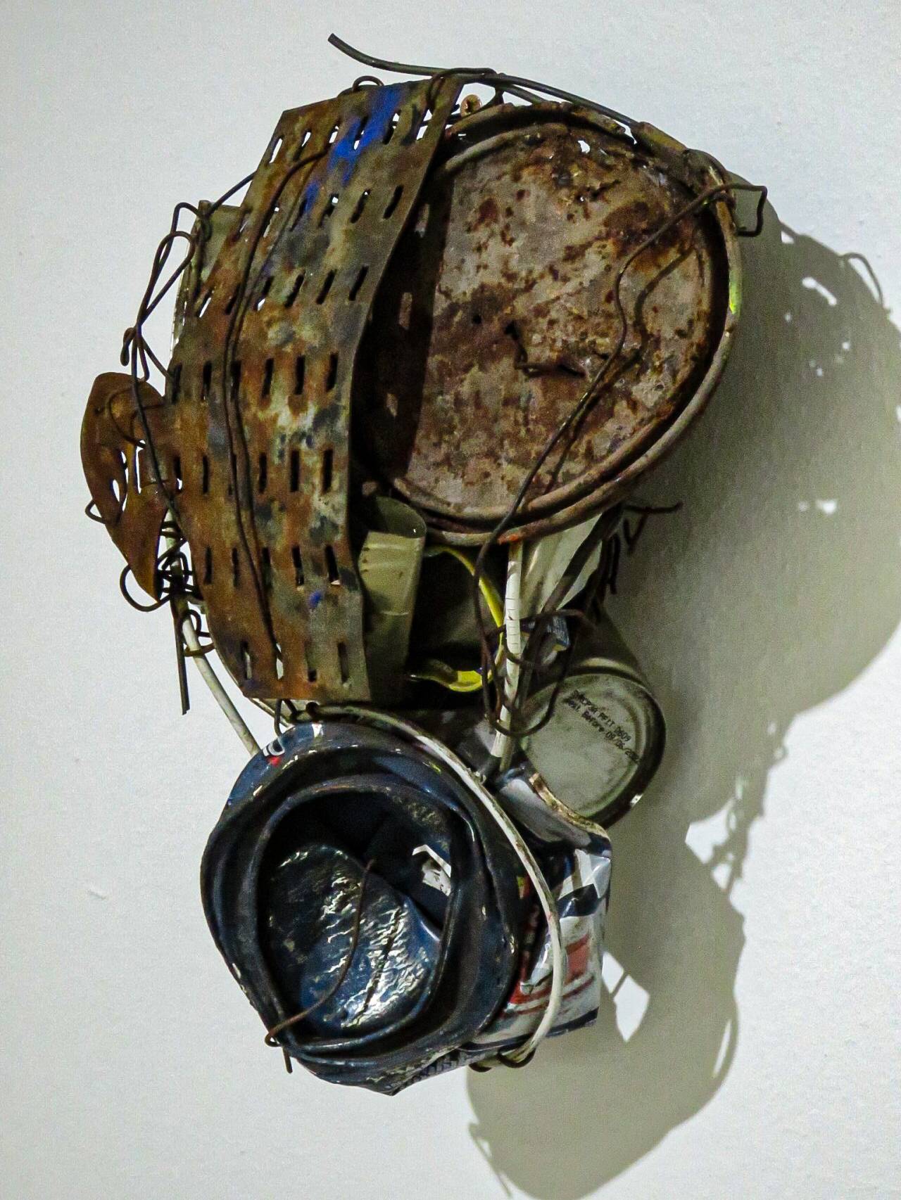 Mask series- This piece is part of a series of masks created during the COVID lockdown, capturing the profound  impact those days had on my mental, emotional, and physical state. On this particular day, I could  hear the scream of my soul as I wrestled with the echoes of my thoughts. The uncertainty of when—  or if—it would end became a relentless torment, while the fear of the lasting effects on humanity  loomed like a shadow. By using discarded, lifeless objects, I find a way to create and breathe life into  a society that is slowly decaying.